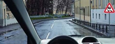 At what distance will the slippery road section start in the settlement?