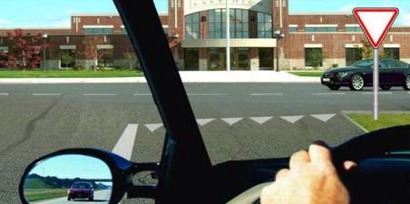 When proceeding to the left, where should a bus driver stop to give way to a passenger car?